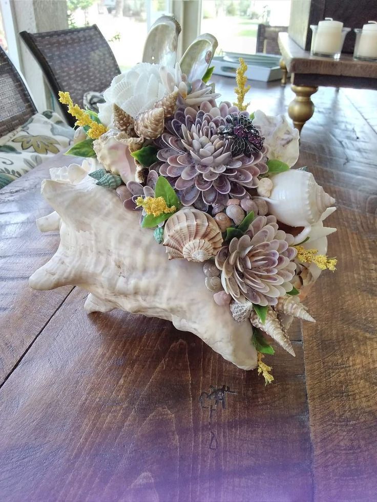 a vase filled with flowers on top of a wooden table