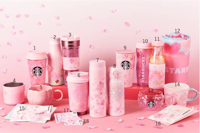 starbucks coffee cups and other items on a pink surface