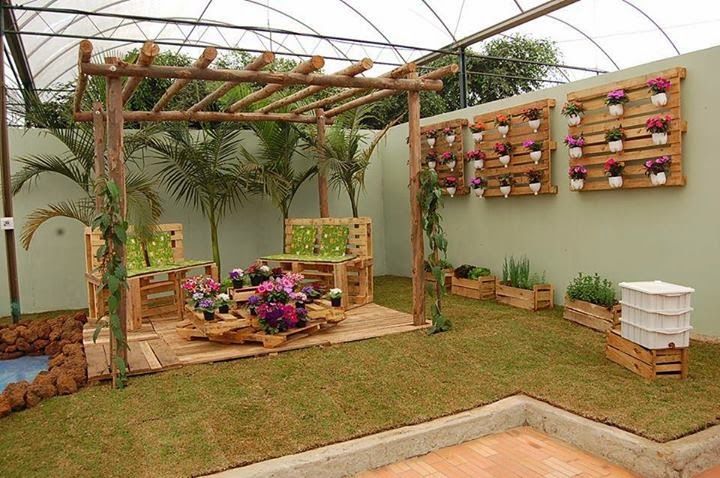 an outdoor garden with wooden pallets and potted plants