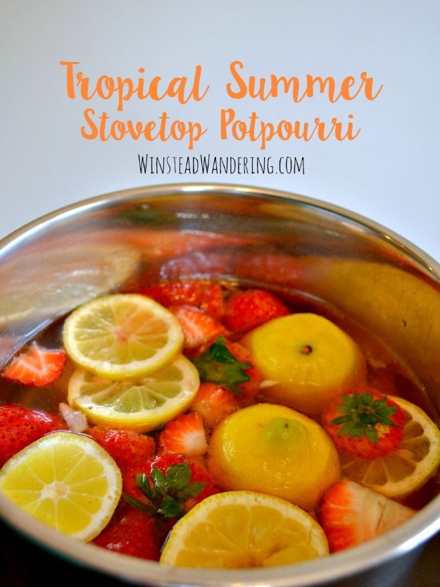 a metal bowl filled with lemons and strawberries