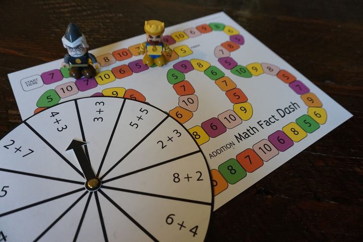 two children's toys sitting on top of a table next to a game wheel