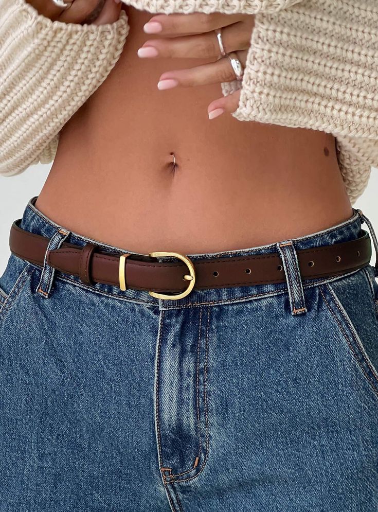 Faux leather belt Gold-toned hardware, buckle fastening Princess Polly Lower Impact 90% reclaimed PU 10% metal Length adjusts from: 14cm - 90cm / 5.5in - 35.4in Brown Belt Outfit Jeans, Belt Fashion Women, Brown Belt Gold Buckle, Classy Belts For Women, Brown Leather Belt Outfit, Aesthetic Belts, Amber Accessories, Brown Belt Outfit, Aesthetic Belt