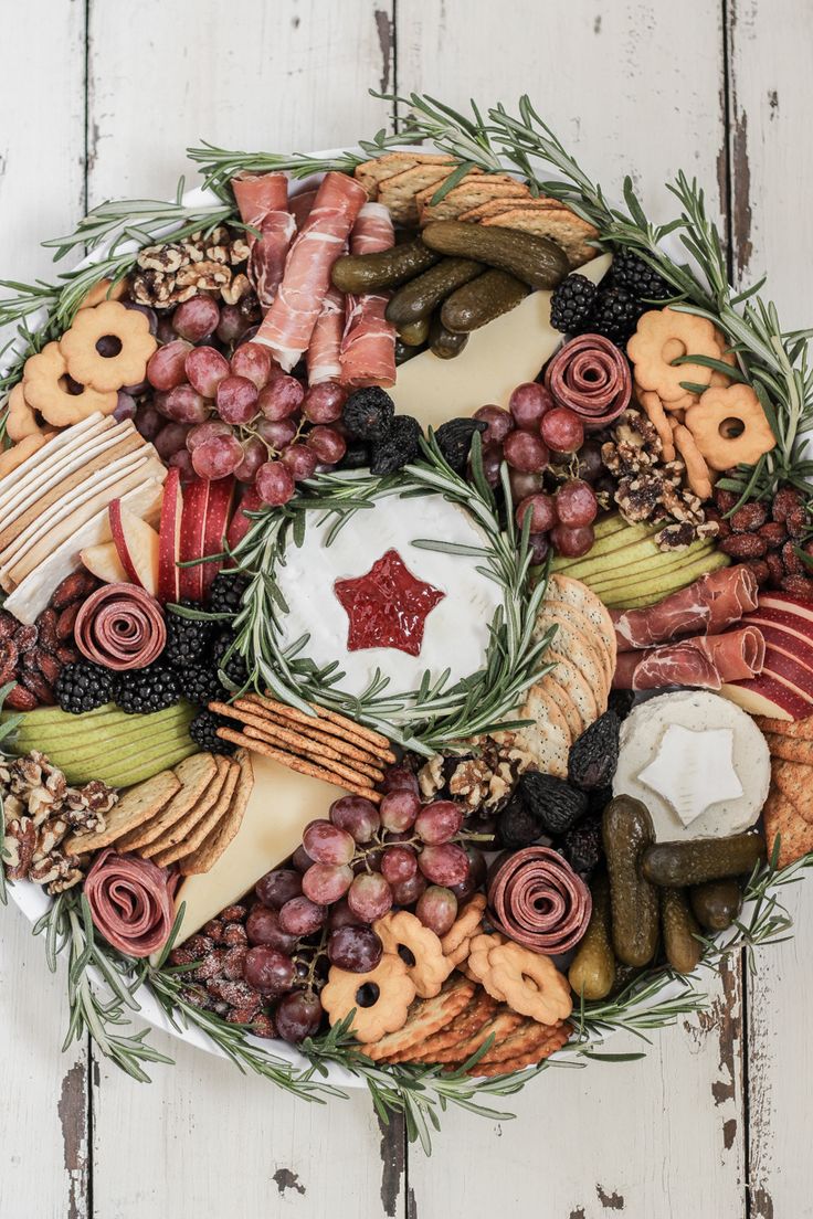 a wreath made out of cheeses, meats and vegetables