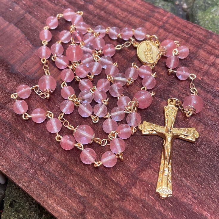 This precious handmade catholic rosary is made with gold tone wire and chain, with natural 6,8mm rose quartz beads ,gold plates crucifix and Sacred Family centerpiece. The quartz beads are 100% natural. This Piece is handmade. Each item is send in a small organza bag. Gold Rosary With 8mm Beads For Healing, Handmade Gold Rosary For Healing, Handmade Gold Healing Rosary, Sacred Family, Gold Plates, Catholic Rosary, Rosary Bracelet, Aquamarine Beads, Rosary Catholic