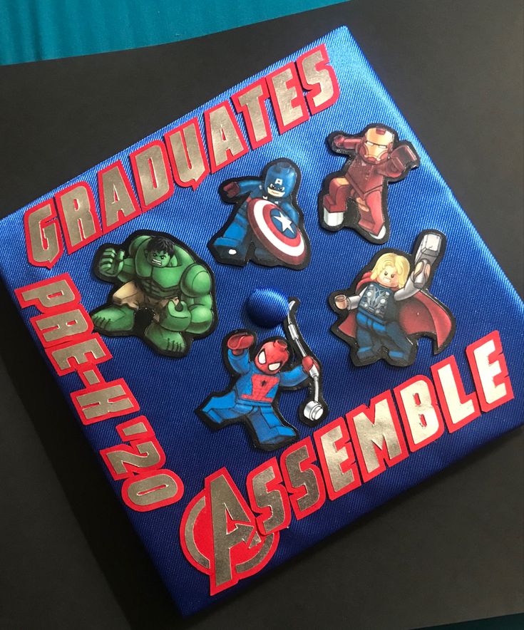 a blue book with avengers stickers on it's cover that says graduates are assembleable