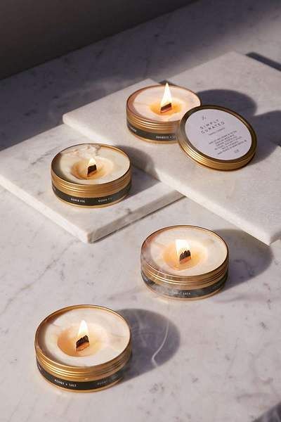 three candles sitting on top of a white counter