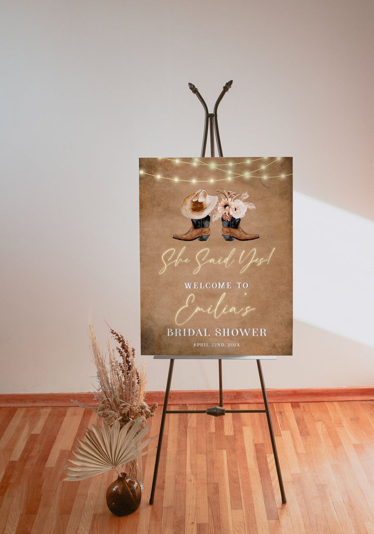 a welcome sign with lights on it in front of a wooden floor and white walls