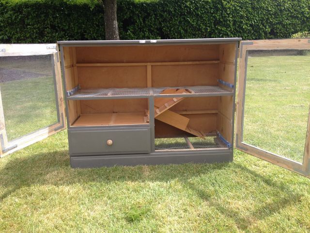 an open cabinet sitting on top of a grass covered field