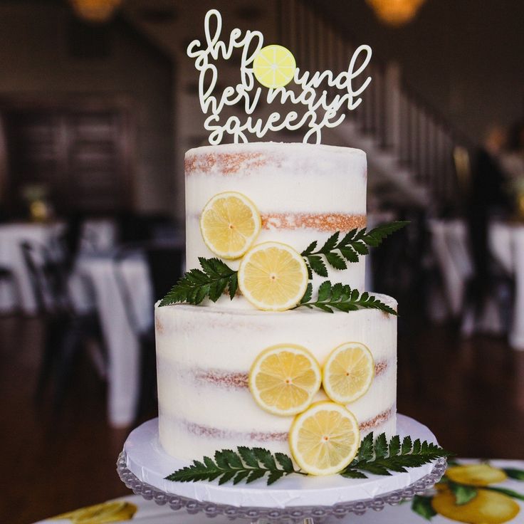 a three tiered cake with lemon slices on top