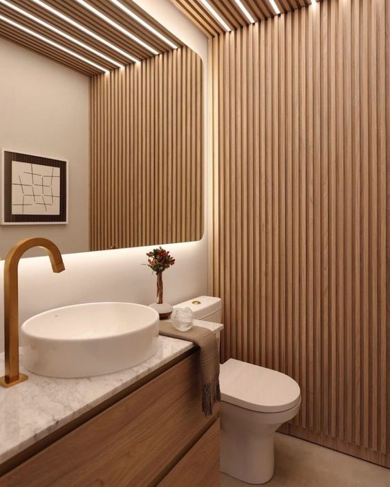 a modern bathroom with wooden slats on the ceiling and white countertop, along with a round sink