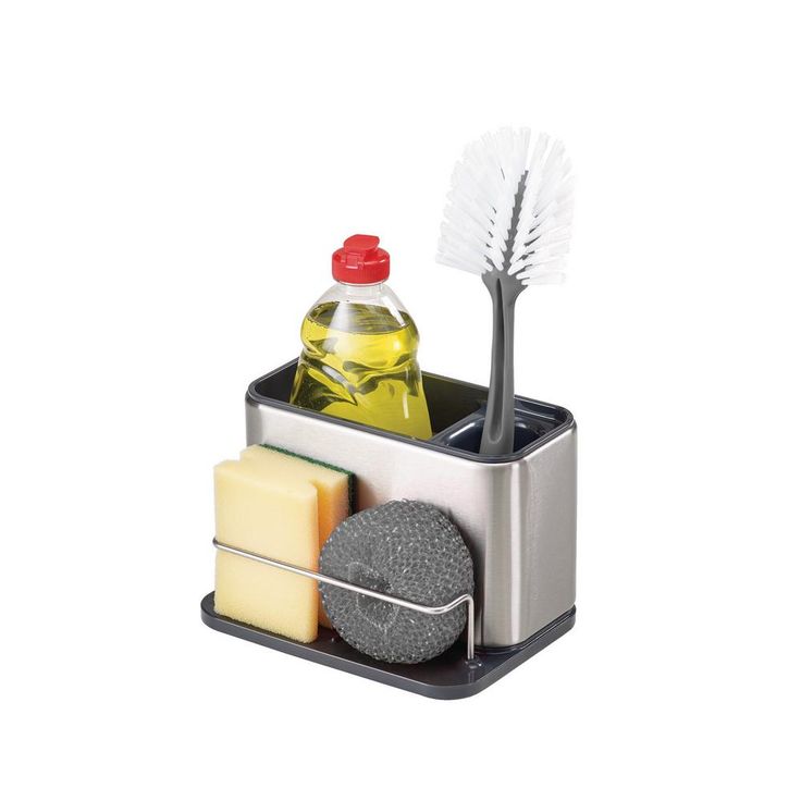 a hand is holding a brush, soap and sponge in a holder on the counter