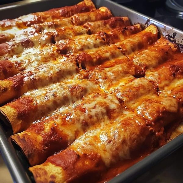 a pan filled with cheese covered pizza rolls