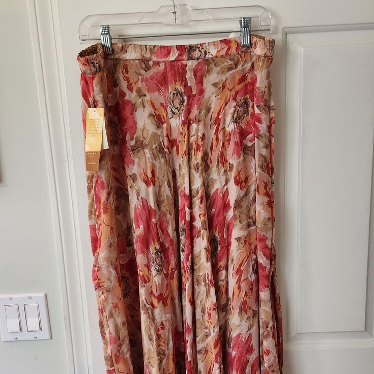 Coldwater Creek Skirt New With Tags Beautiful Flowy Skirt With Elastic Waist In Pretty Shades Of Peach Apricot And Pink. Lined In Tan Colored Print Underneath. Very Pretty Skirt Midi Length Size L Floral Print Long Skirt For Beach, Floral Print Skirted Bottoms For Beach, Beach Skirted Bottoms With Floral Print, Pink Full-length Spring Skirt, Summer Long Lined Skirt, Pink Full-length Maxi Skirt For Spring, Pink Flowy Full-length Skirt, Summer Pink Relaxed Fit Maxi Skirt, Summer Pink Relaxed Maxi Skirt