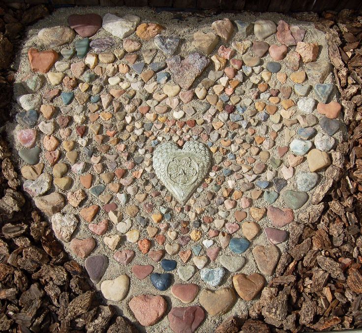 a heart - shaped rock is surrounded by small rocks