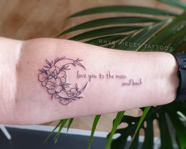 a woman's arm with a tattoo saying love you to the moon and back