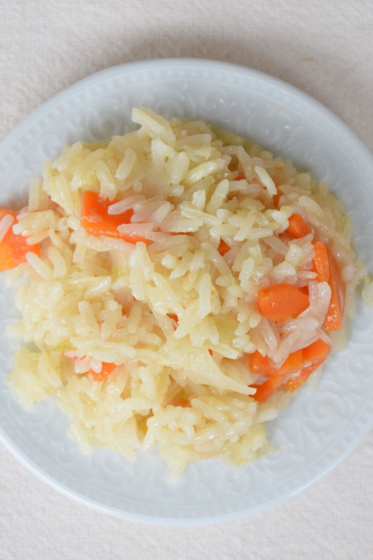 a white plate topped with rice and carrots