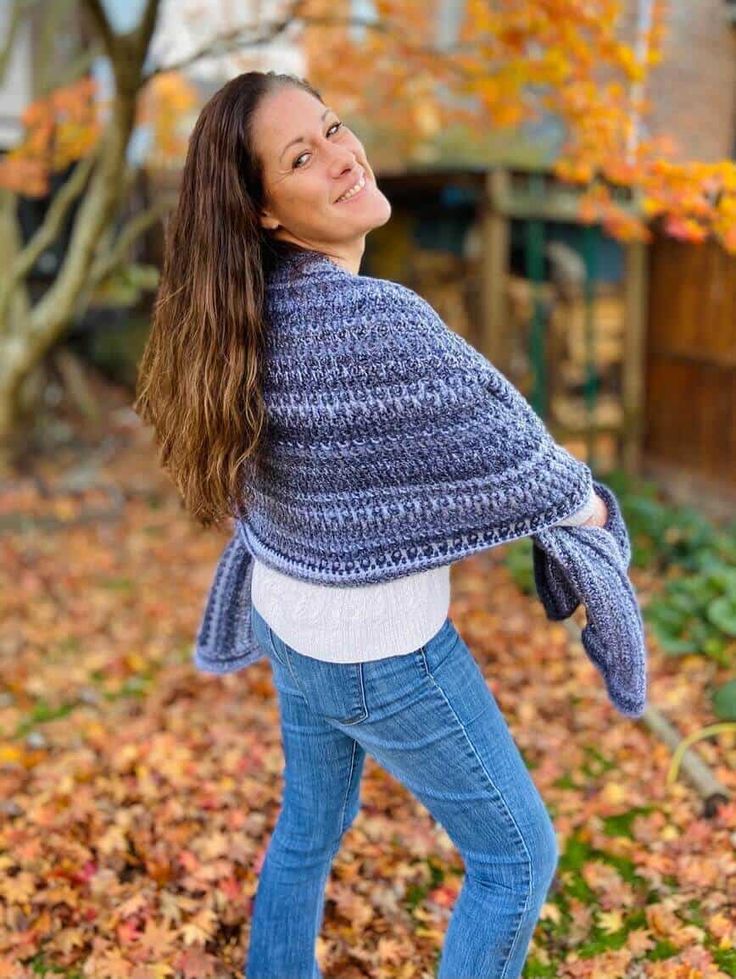 a woman wearing a blue crochet shawl with text that reads, get the free pattern now