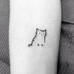 a black and white photo of a cat tattoo on the left arm, with an outline of a cat behind it