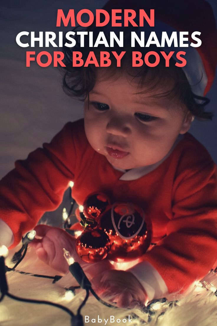 a baby wearing a red sweater and christmas lights with the words modern christian names for baby boys