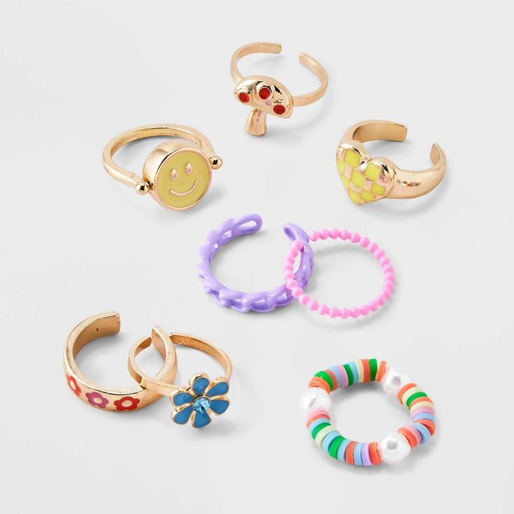 six pairs of rings with smiley faces on them, all in different colors and sizes