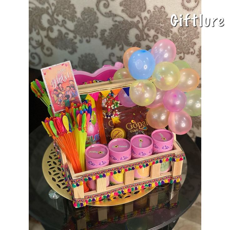 a table topped with lots of balloons and confetti