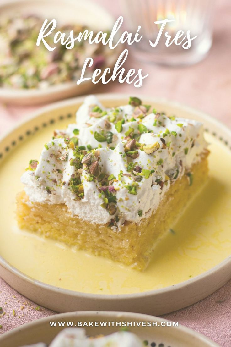 a close up of a piece of cake on a plate with whipped cream and pistachio