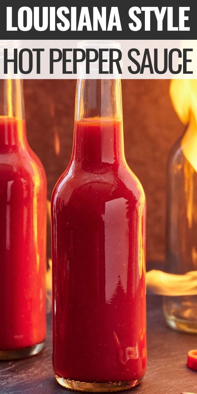 two bottles filled with hot pepper sauce sitting on top of a table next to each other