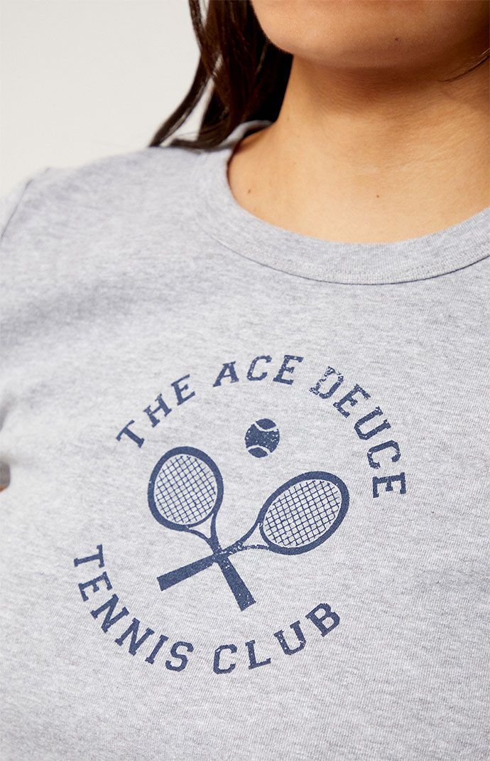 a close up of a person wearing a t - shirt with tennis rackets on it