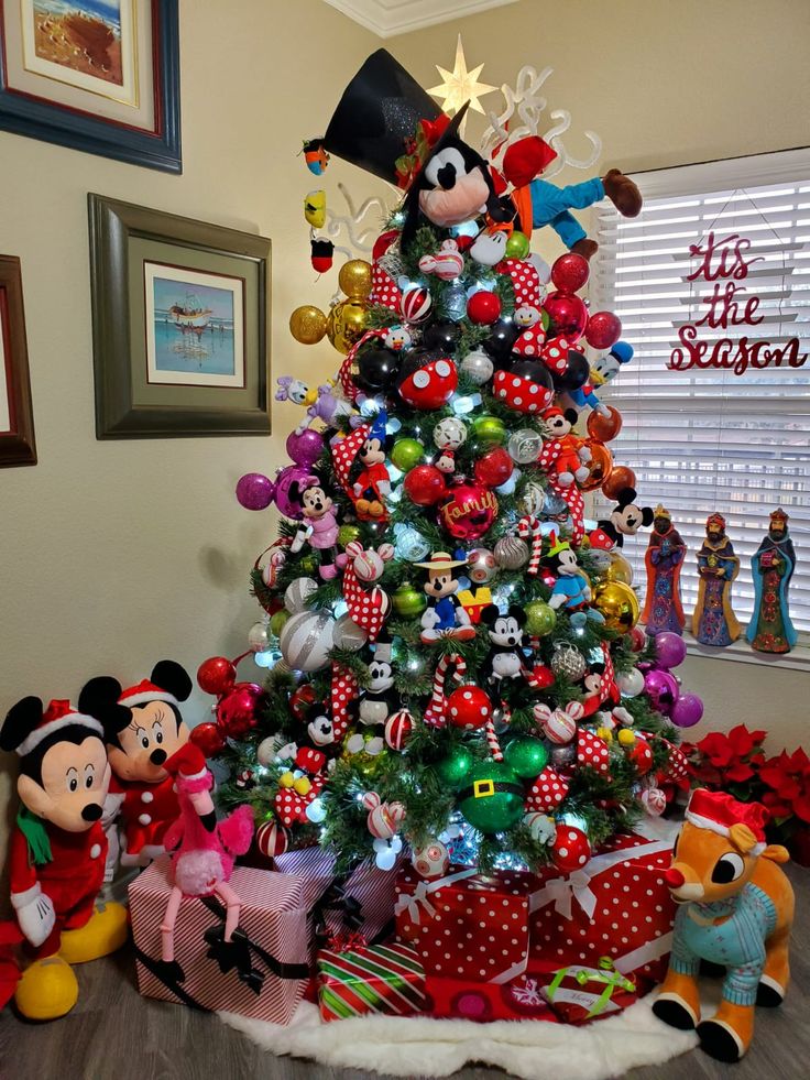 a mickey mouse christmas tree decorated with ornaments