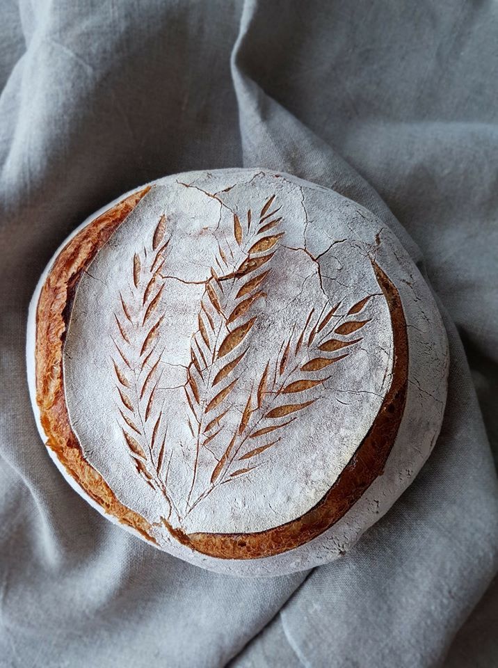 a cake that has been decorated with leaves on it and is sitting on top of a cloth