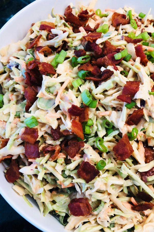 a white bowl filled with coleslaw and bacon