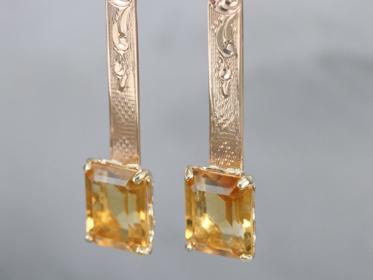 These richly hued citrine drop earrings are bold and elegant! The bar in the center is antique, beautifully etched rose gold. At the very top are the earring wires, hinged lever backs which are brand new, 14k yellow gold with a simple polished design. These are comfortable to wear and very secure! Metal: 14K Rose and Yellow Gold Gem: 2 Citrines totaling 7.96 Carats Gem Measurements: 9 x 11 mm, Emerald Cut Earrings Length: 50 mm Earrings Width: 9 mm Marks: "14K" Stamped on the Findings Luxury Yellow Gold Rectangular Earrings, Luxury Yellow Gold Earrings With Rectangular Stone, Emerald Cut Earrings, Citrine Drop Earrings, Cut Earrings, Earring Wires, Cameo Ring, November Birthstone, Gold Bar