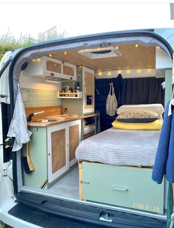 the interior of a camper van with its bed pulled up to it's side