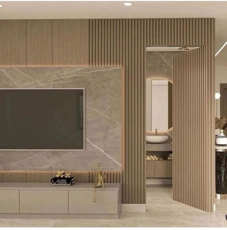 a large tv mounted to the side of a wall in a room with marble walls