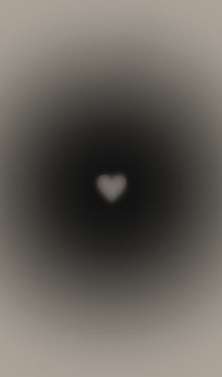 a black hole with a white heart in the center and light at the end that is very dark