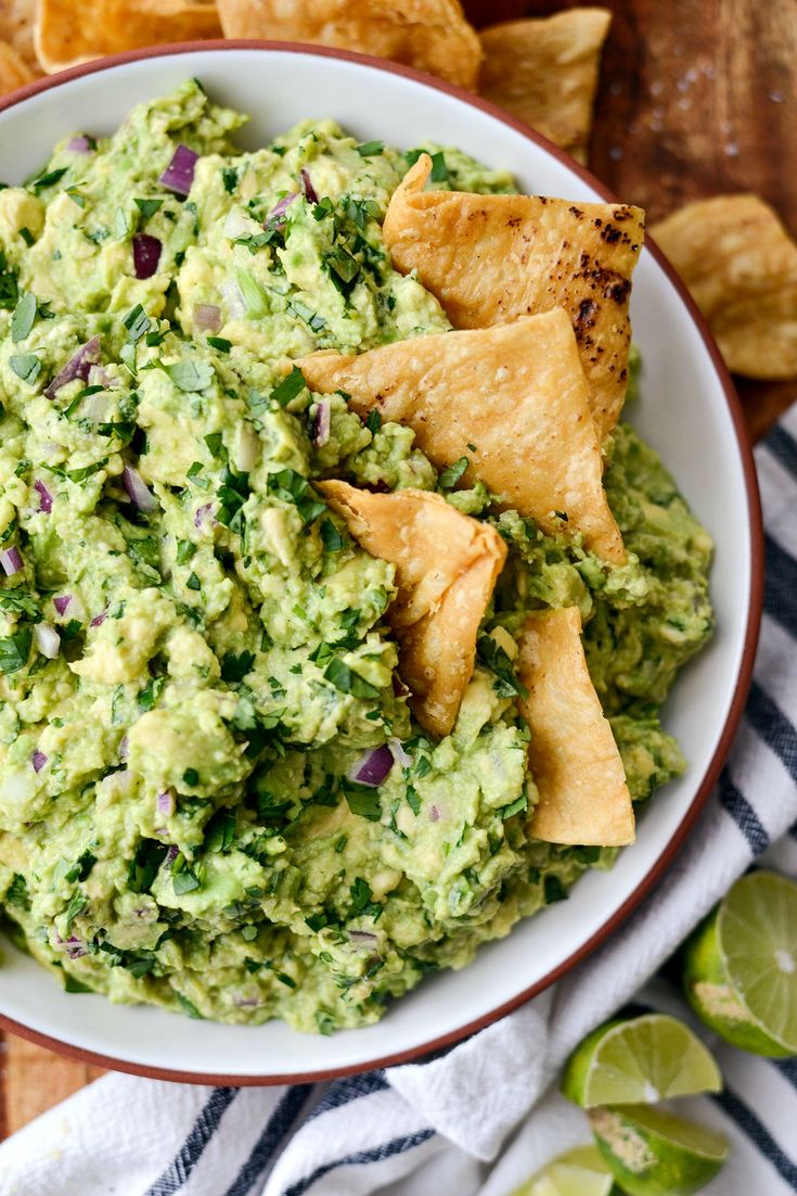 a bowl filled with guacamole and tortilla chips