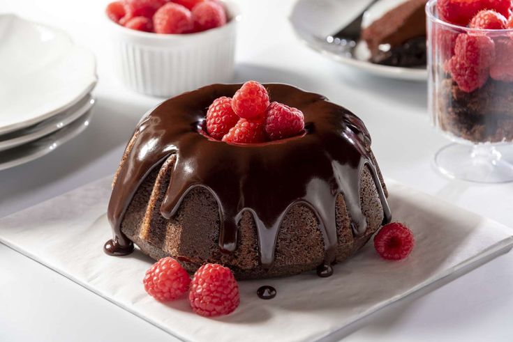 a chocolate bundt cake with raspberries on top