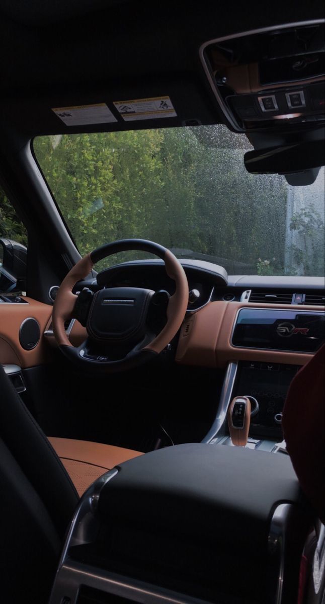 the interior of a vehicle with dashboard, steering wheel and center console in front of it