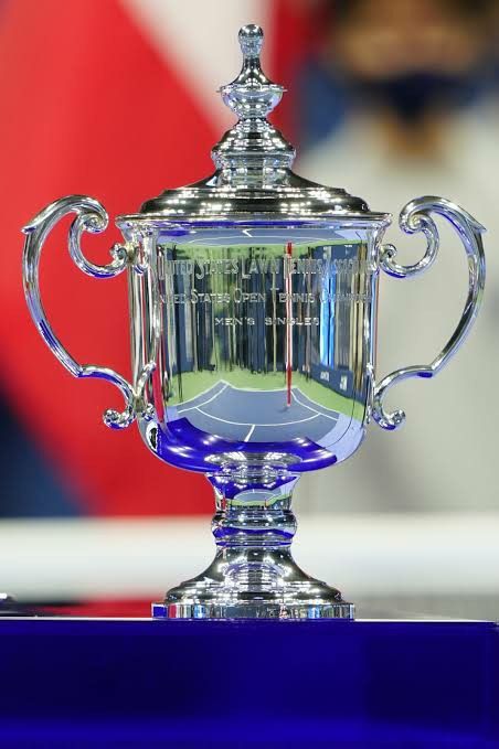 the trophy is on display in front of a large red and white flag behind it