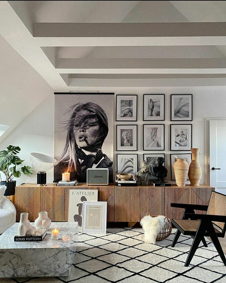 a living room filled with lots of furniture and pictures on the wall above it's coffee table