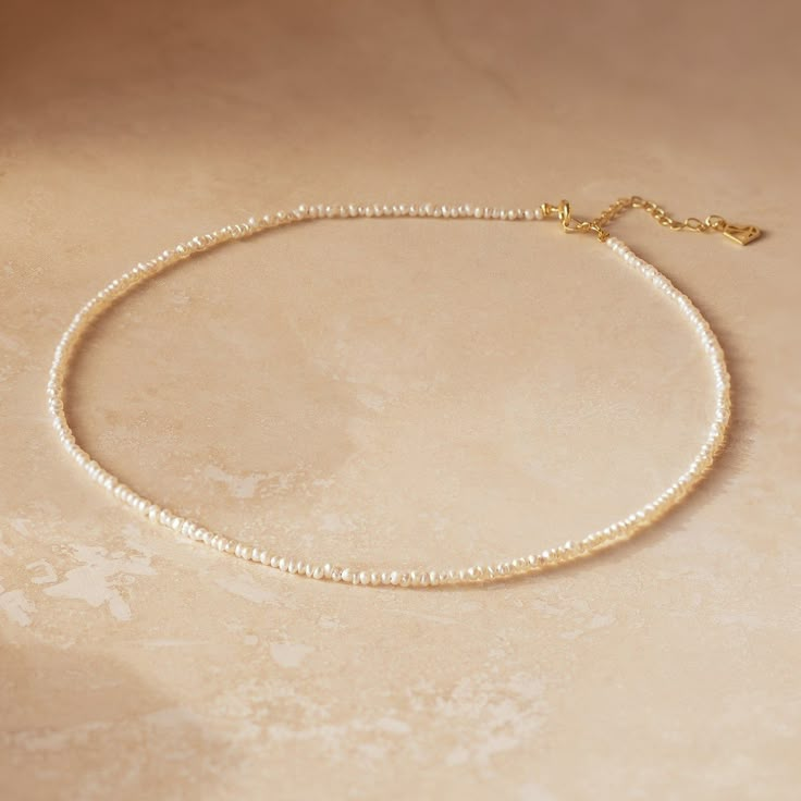 💝Gift-Worthy: Perfect for any occasion 💝 Our Brinley Pearl Choker Necklace is a gift that anyone would be happy to receive. The unique, baroque style pearl beads give the necklace personality while the dainty size of the chain is minimalist and can be worn every day. Material: High Quality Solid 925 Sterling Silver, Freshwater Pearl Finish: Sterling Silver ∙ 18K Gold Featuring a Pearl Beaded Choker with an adjustable chain of 14 inches to 16 inches SKU: RR-NR121 Single Strand Baroque Pearl Necklace Gift, Elegant Rondelle Beaded Necklaces As Gift, Elegant Rondelle Beaded Necklaces For Gifts, Minimalist Beaded Necklace With Pearl Drop As Gift, Minimalist Beaded Necklace With Pearl Drop For Gift, Baroque Pearl Single Strand Necklace For Gift, Dainty Pearl White Pearl Necklace For Jewelry Making, Delicate Gold Single Strand Pearl Necklace, Gift Baroque Pearl Single Strand Necklace