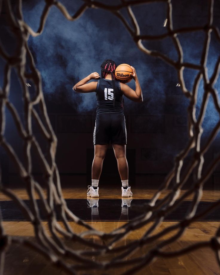 a woman holding a basketball in her hands