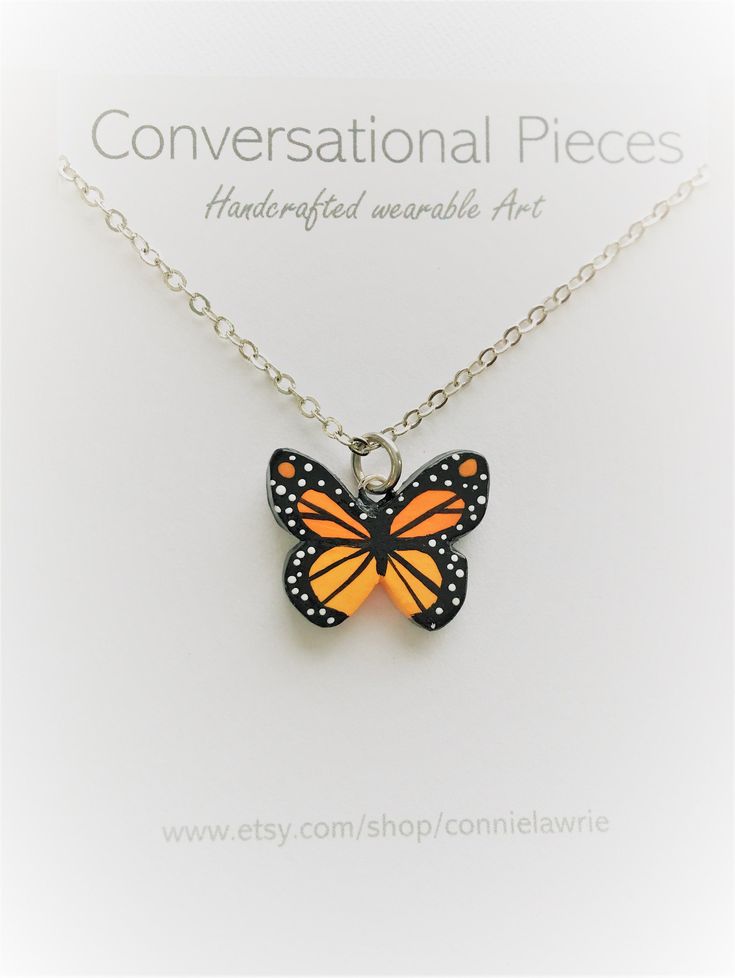 "This beautiful Monarch Butterfly pendant is made by hand using polymer clay. I then intricately paint each pendant to a striking Monarch Pattern. I've finished off this design using a dainty silver chain. This necklace looks pretty by itself, yet it also works great to be worn in layers with your other jewelry. This pendant measures just over 1/2 inch and is painted in detail on both sides! I do offer a variety of chain lengths. I love the beauty of the Monarch. This necklace will add a pop of Real Butterfly Necklace, Orange Butterfly Jewelry Gift, Orange Butterfly Jewelry For Gifts, Monarch Butterfly Necklace, Nature-inspired Butterfly Charm Necklaces, The Monarch, Butterfly Necklace, Butterfly Pendant, Monarch Butterfly