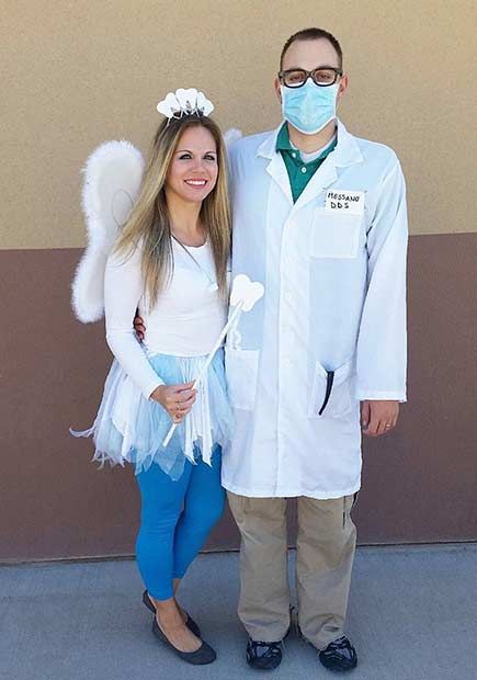 a man and woman in white lab coats standing next to each other with masks on