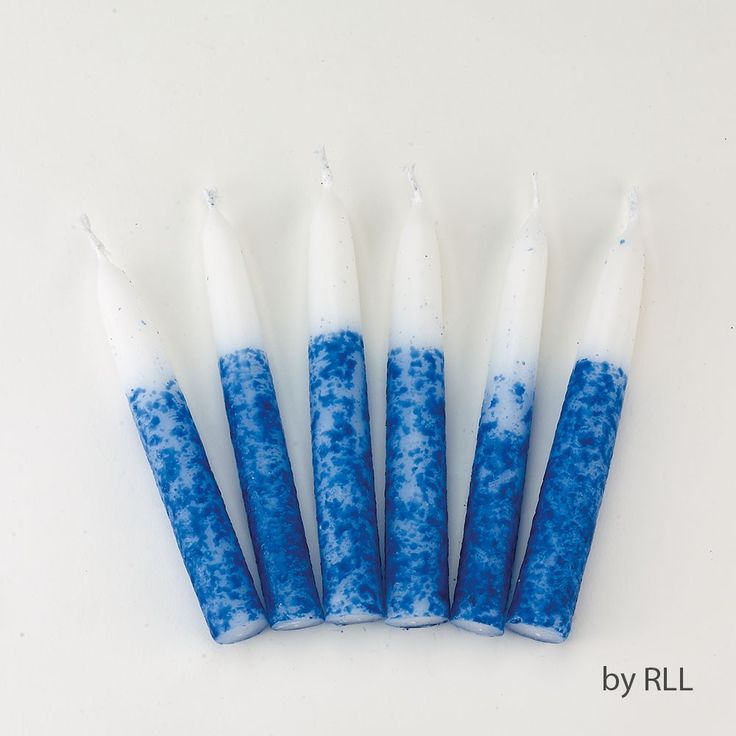 six blue and white candles are lined up