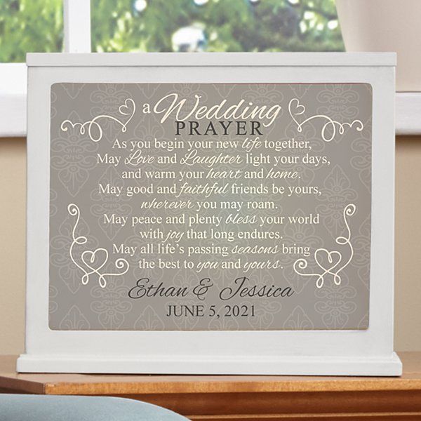 a wedding prayer sign sitting on top of a table