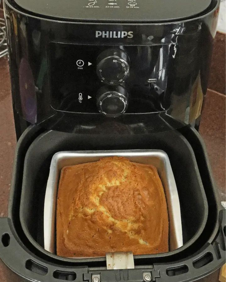 a close up of a bread maker on a counter with a loaf of bread in it