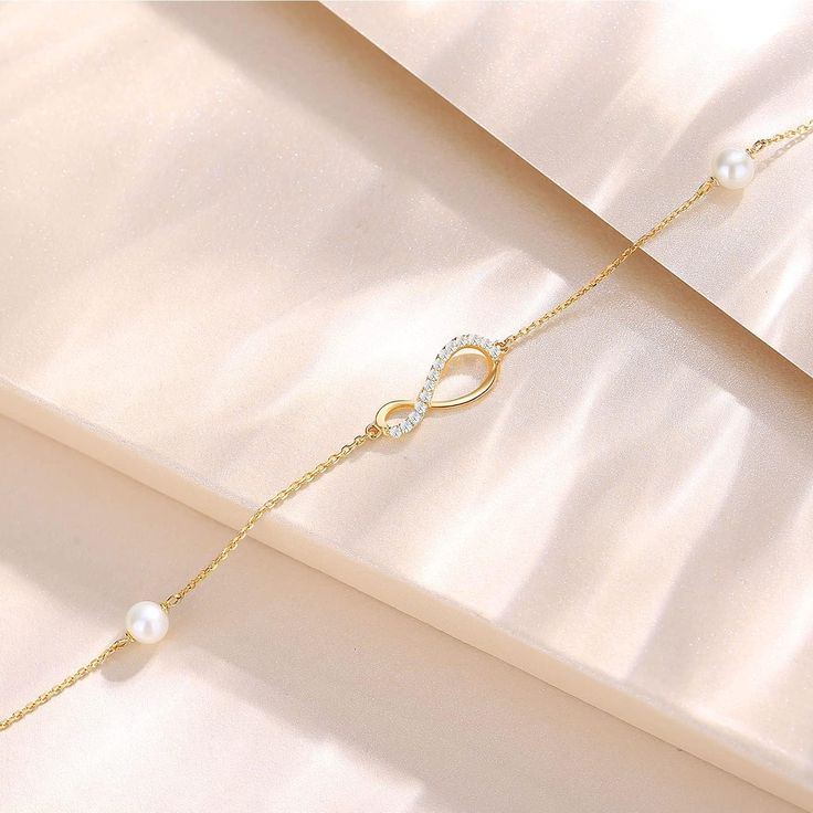 💕 STYLISH DESIGN 💕 The infinity sign means always and forever, the 14k real gold infinity pearl bracelet designed by FANCIME is a symbol of eternal love and friendship. Adjustable design 6.7”+0.59''+0.59” extend chain, adjusts to fit most wrists. 💕 FINE JEWELRY 💕 The FANCIME Solid 14k Gold Bracelet is well crafted in 14k gold with Au585 stamp. (In real 14 carat gold, not just covering). Two freshwater cultured pearls make this bracelet more elegant and luxury. All metals are lead free, nicke Elegant Infinity Bracelets For Mother's Day, Elegant Infinity Bracelet For Mother's Day, Elegant Infinity Bracelets For Formal Occasions, Elegant Gold Pearl Bracelet For Mother's Day, Elegant Infinity Bracelets For Wedding, Elegant Wedding Infinity Bracelets, Elegant Rose Gold Infinity Bracelet, Elegant Yellow Gold Infinity Bracelet, Infinity Sign Meaning