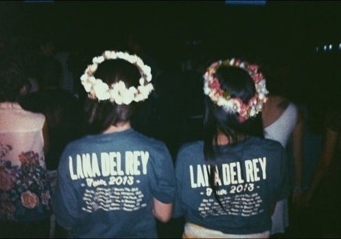 two people wearing t - shirts with flowers in their hair