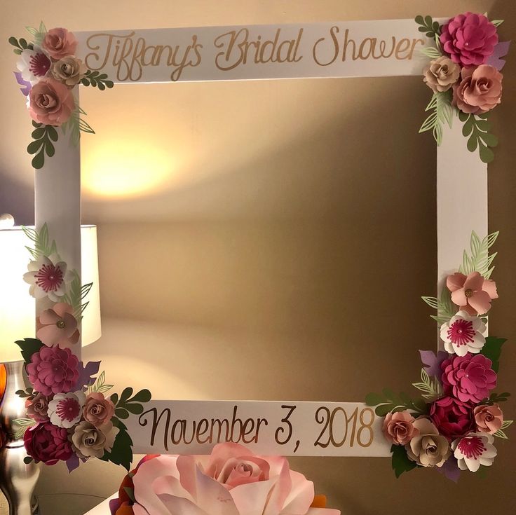 a mirror decorated with flowers and the name tiffany's bridal shower